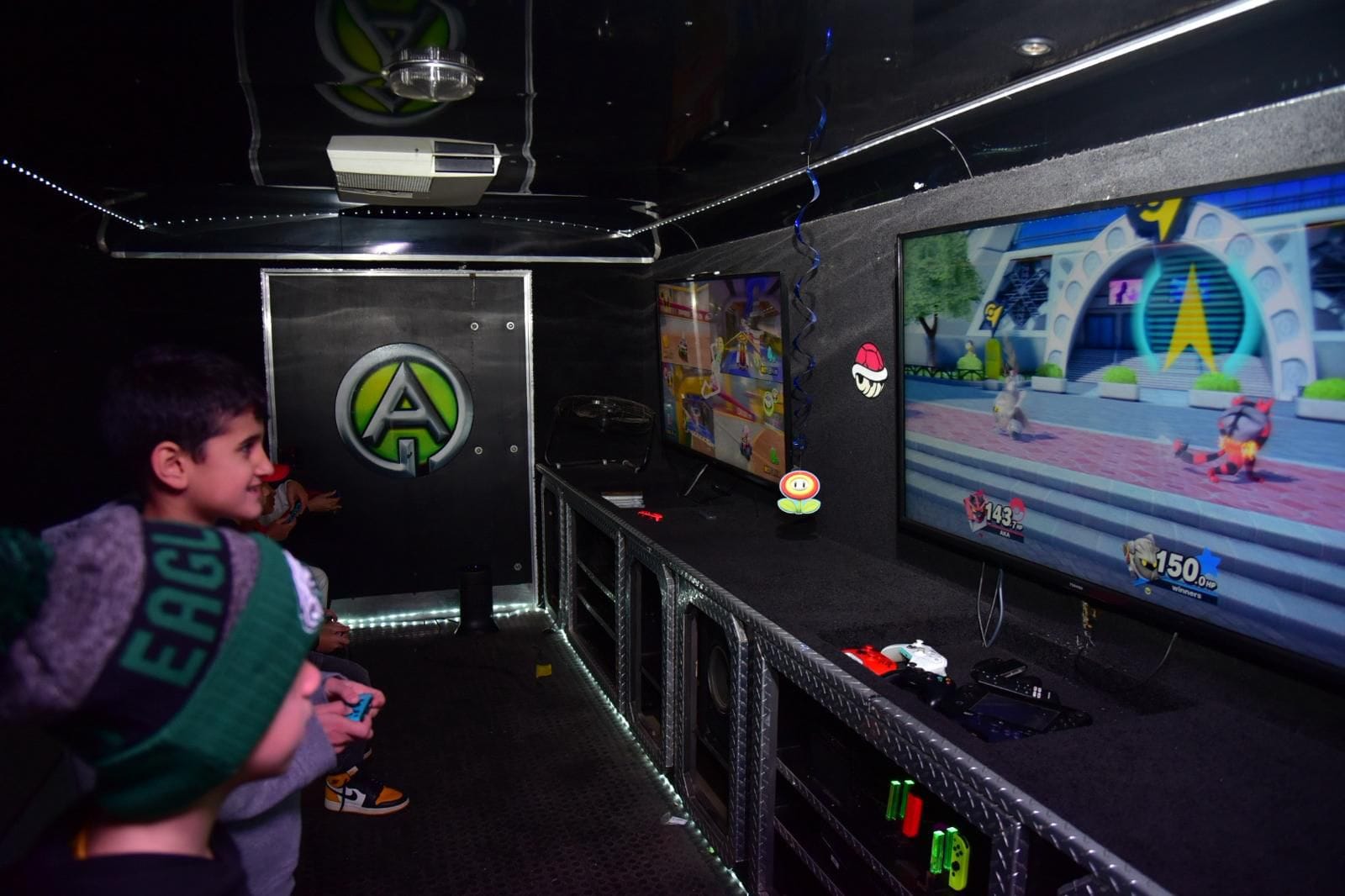 Friends competing on the Game Zone Events gaming truck at a graduation celebration in Ontario
